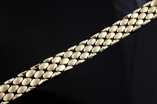 A modern textured 14ct gold shaped link bracelet, 19cm.